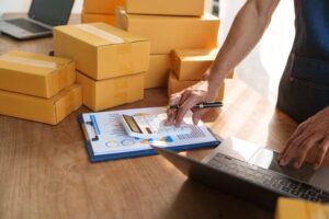 Thriving small businesses, home offices, manage packaging, shipping, client relations using laptop.