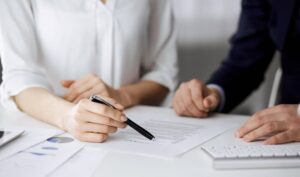 businessman and woman discussing contract in office