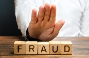 A man rejects the word Fraud with his hand