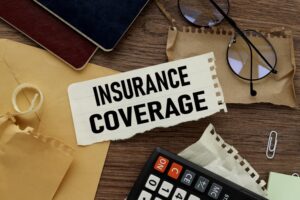 Insurance coverage text on torn paper on the background of different stationery