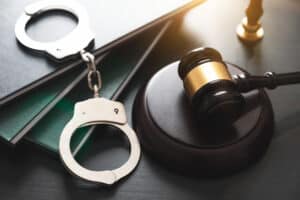 Handcuff, law books and gavel