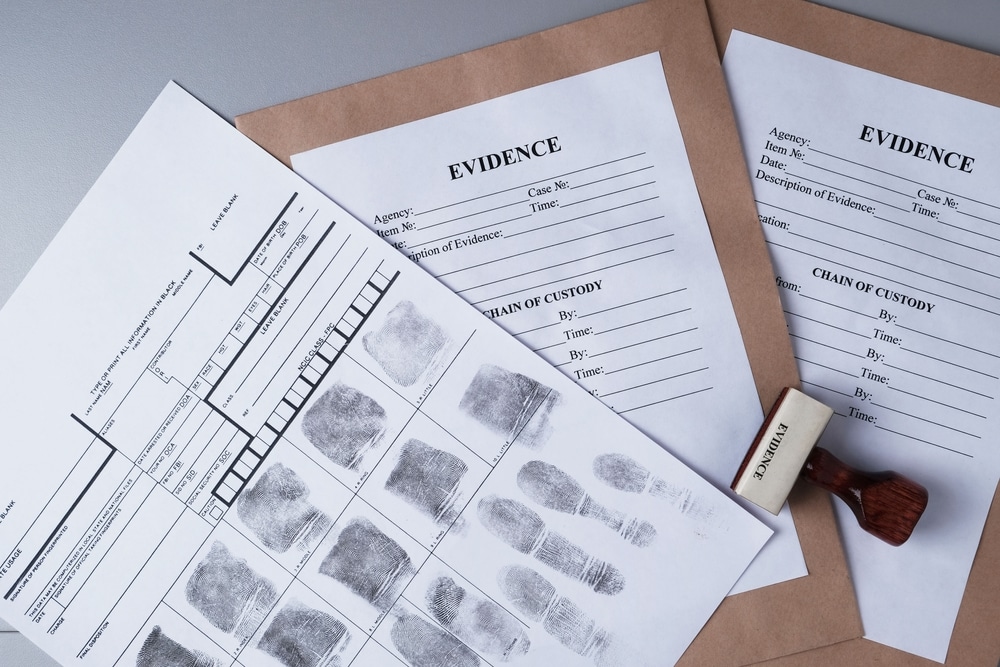 Fingerprint card and evidence files representing criminal record documentation.