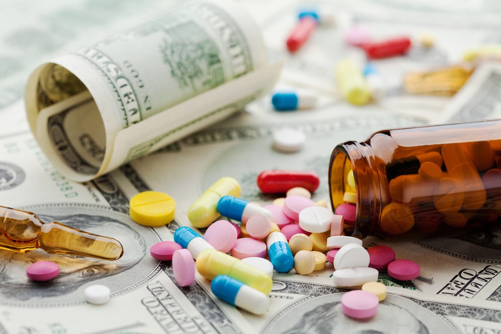 Prescription pills spilled on cash highlighting drug charge consequences in Florida