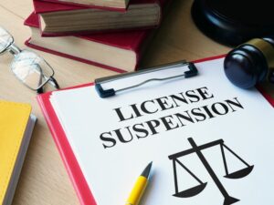 License Suspension is written on a paper.