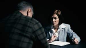 Probation or parole officer questioning an individual during a supervision meeting